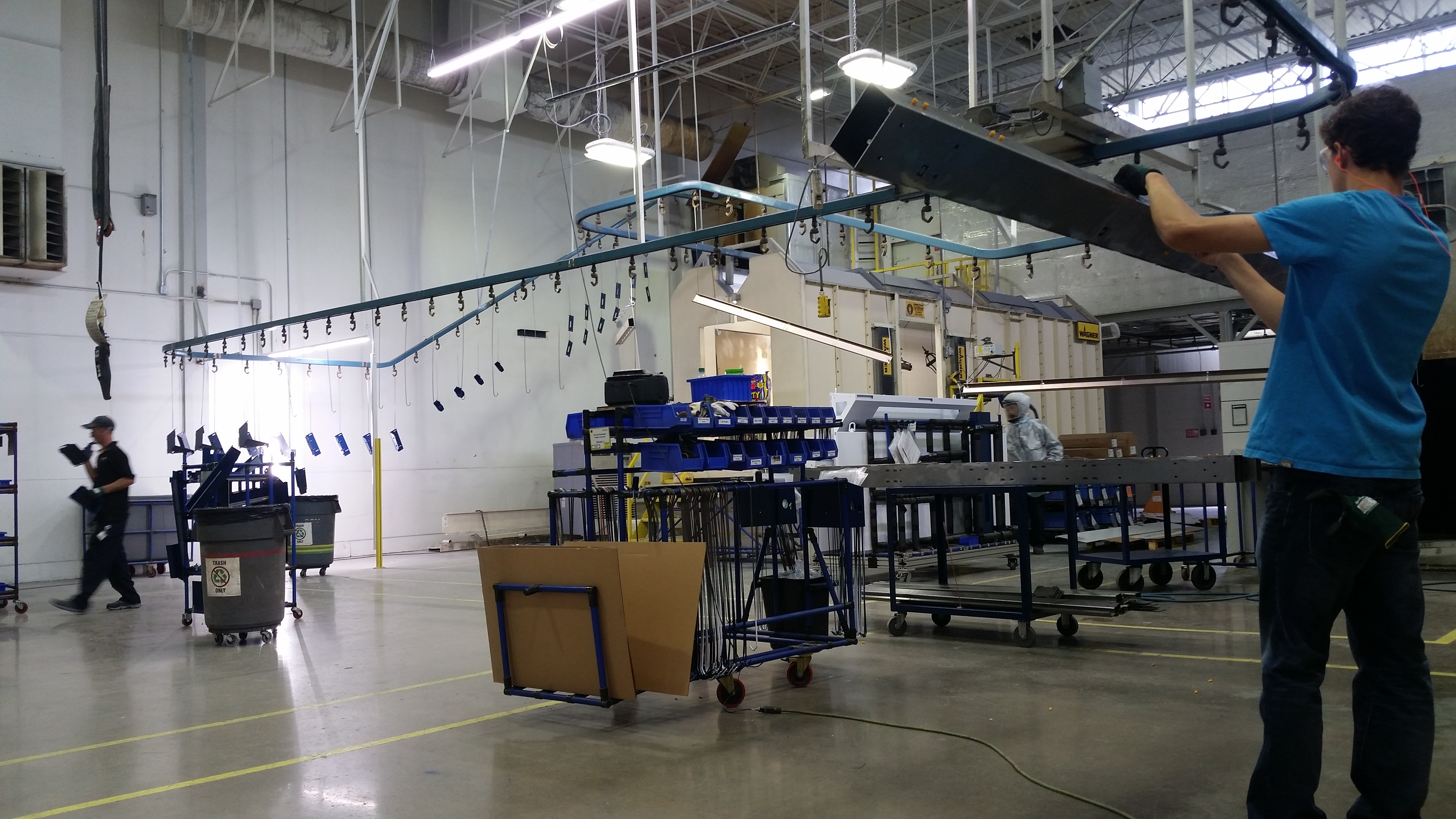 Production line floor with hanging conveyor and operator staging area